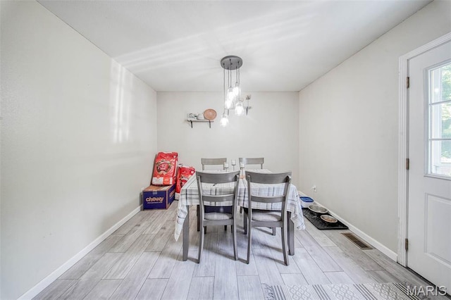 24478 Trolley Ln, Saint Robert, MO 65584 - dining room featuring light wood finished floors, baseboards, and a chandelier