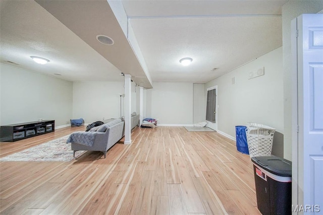 24478 Trolley Ln, Saint Robert, MO 65584 - sitting room featuring light wood-style floors, baseboards, and a textured ceiling