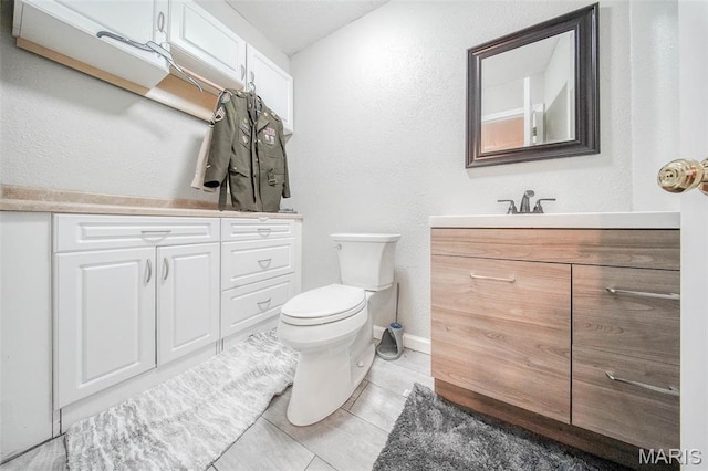 24478 Trolley Ln, Saint Robert, MO 65584 - bathroom featuring vanity, toilet, baseboards, and a textured wall