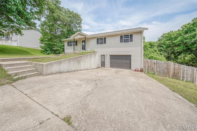 24478 Trolley Ln, Saint Robert, MO 65584 - view of front of house featuring driveway and a garage