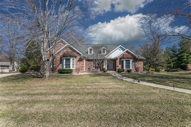 view of front of house featuring brick siding and a front yard