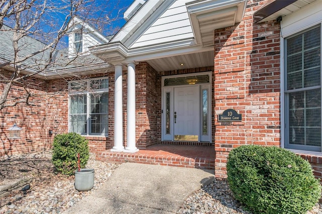 property entrance featuring brick siding