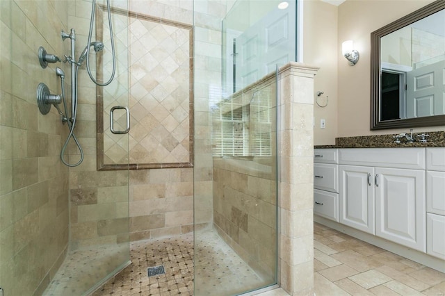 bathroom with a shower stall and vanity