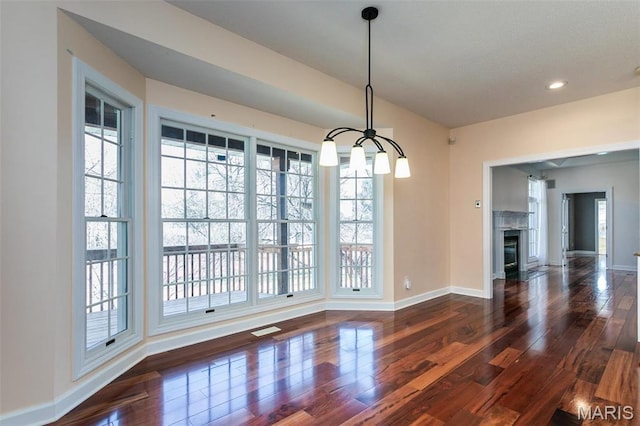10 Dunbridge Ct, Glen Carbon, IL 62034 - unfurnished dining area featuring wood finished floors, recessed lighting, a glass covered fireplace, and a chandelier