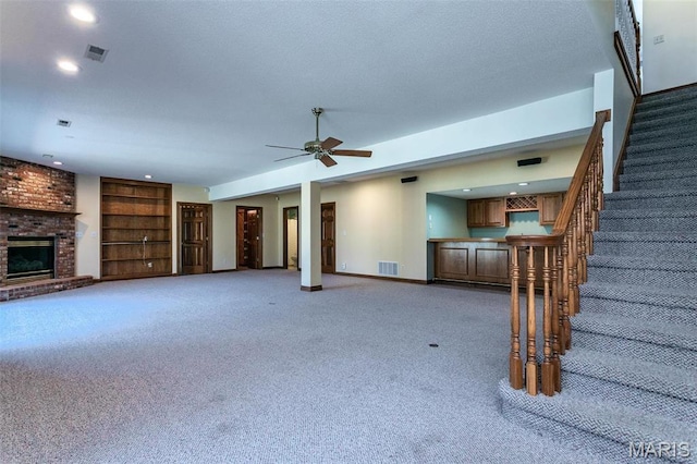 10 Dunbridge Ct, Glen Carbon, IL 62034 - unfurnished living room with light carpet, recessed lighting, stairway, a brick fireplace, and ceiling fan