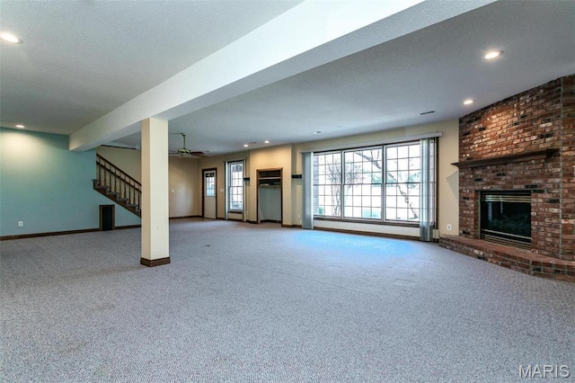 10 Dunbridge Ct, Glen Carbon, IL 62034 - unfurnished living room with carpet flooring, recessed lighting, a fireplace, stairs, and ceiling fan