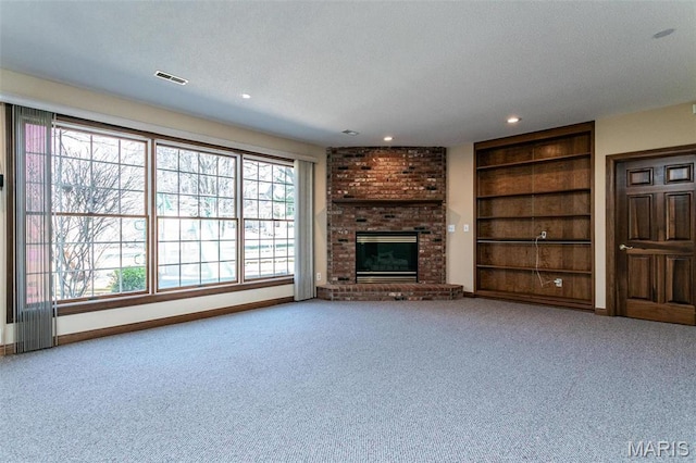 10 Dunbridge Ct, Glen Carbon, IL 62034 - unfurnished living room featuring built in features, carpet, a brick fireplace, and recessed lighting