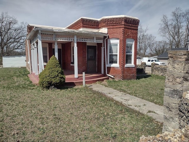 411 N Desloge Dr, Desloge, MO 63601 - view of front of property with brick siding, a front lawn, and covered porch