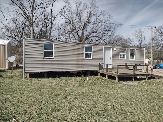 411 N Desloge Dr, Desloge, MO 63601 - rear view of house featuring a deck, a yard, an outbuilding, and a storage unit