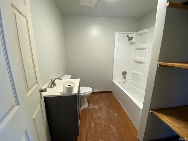 full bathroom featuring toilet, vanity, wood finished floors, and shower / washtub combination