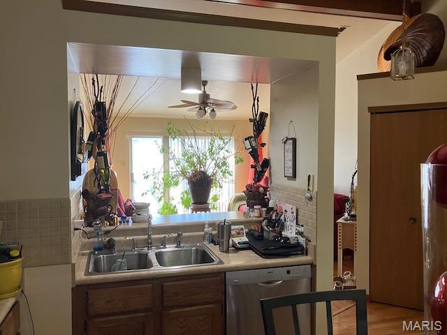 4304 Inlet Isle Dr, Florissant, MO 63034 - kitchen featuring dishwasher, a sink, light countertops, and tasteful backsplash