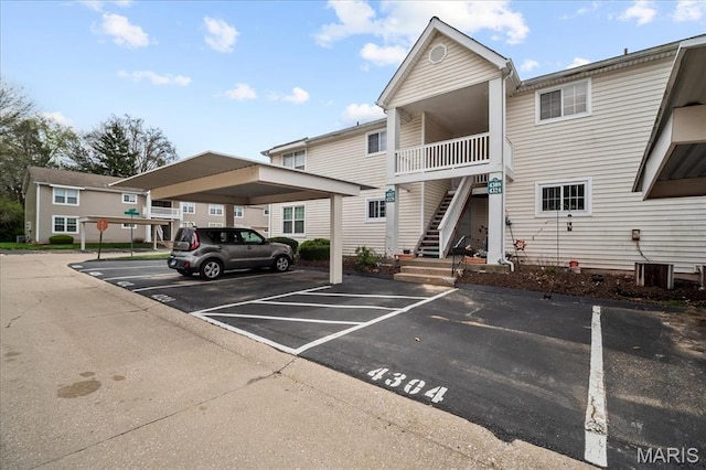 4304 Inlet Isle Dr, Florissant, MO 63034 - view of building exterior featuring covered and uncovered parking and stairway