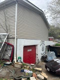 19050 Sikes Rd, Saint Genevieve, MO 63670 - view of side of property with a garage and stucco siding