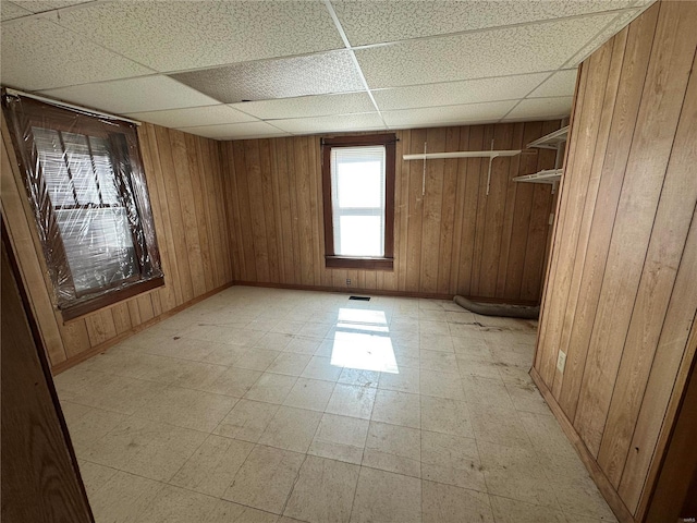 104 Selma St, Sikeston, MO 63801 - unfurnished room with light floors, a drop ceiling, and wooden walls