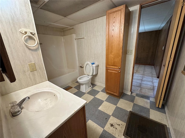 104 Selma St, Sikeston, MO 63801 - full bathroom with tile patterned floors, a drop ceiling, bathtub / shower combination, vanity, and toilet