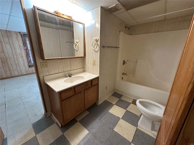 104 Selma St, Sikeston, MO 63801 - full bath with a drop ceiling, tile patterned floors,  shower combination, toilet, and vanity