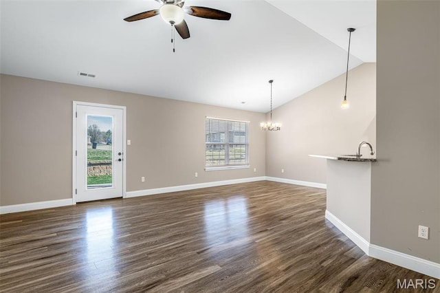 533 Windsor Ln, Farmington, MO 63640 - unfurnished living room with ceiling fan, a chandelier, baseboards, dark wood-style flooring, and vaulted ceiling