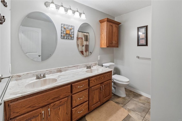bathroom with toilet and double vanity