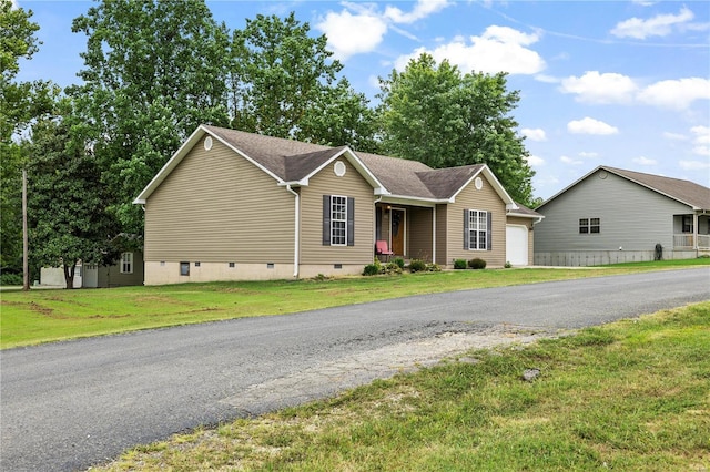 ranch-style home with crawl space, a garage, a front yard, and asphalt driveway