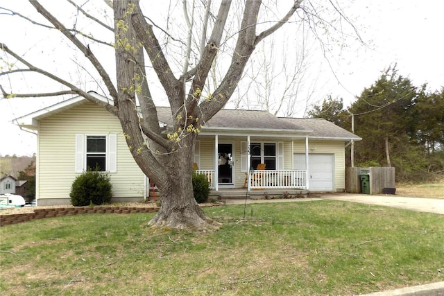 view of front of property with covered porch, a garage, concrete driveway, and a front yard