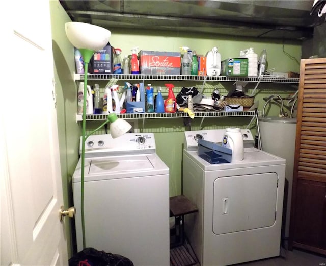 laundry area with independent washer and dryer and water heater