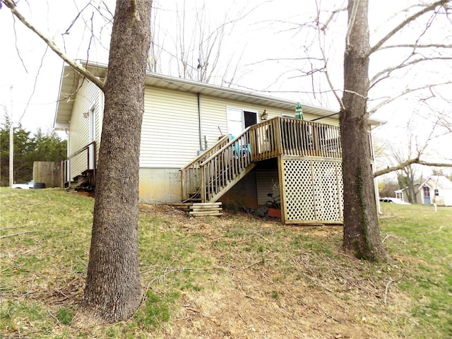 rear view of property with stairway and a wooden deck