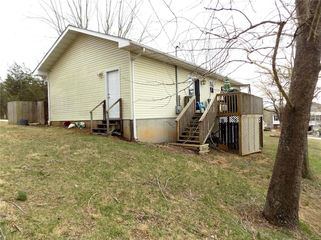 back of house featuring entry steps, stairs, and a deck