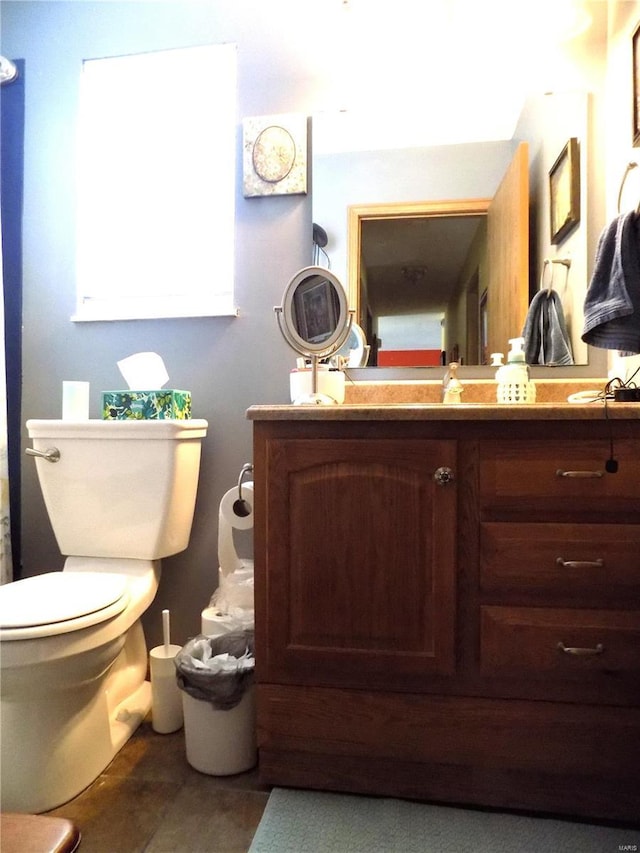 bathroom featuring toilet and vanity