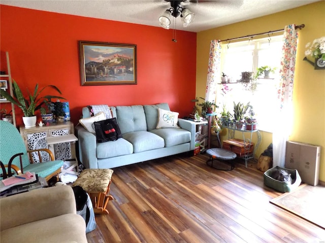 living room featuring a ceiling fan and wood finished floors
