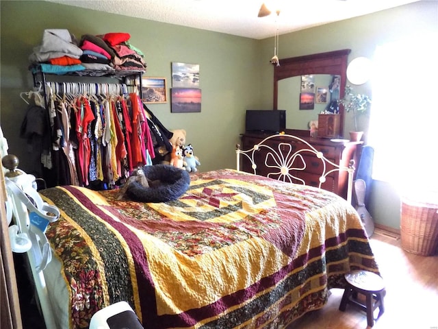 bedroom with wood finished floors