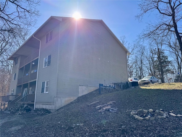 view of side of home featuring a balcony