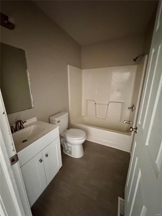 bathroom with toilet, vanity, and bathing tub / shower combination