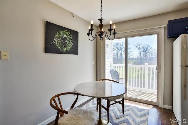 480 Benton Dr Unit J, Saint Peters, MO 63376 - dining room featuring baseboards, a chandelier, and dark wood-style flooring