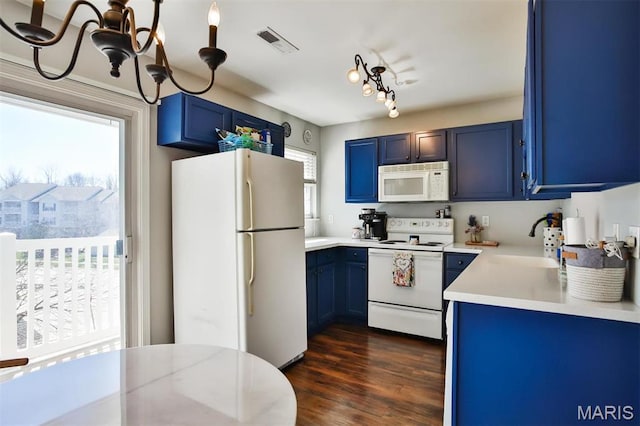 480 Benton Dr Unit J, Saint Peters, MO 63376 - kitchen featuring white appliances, blue cabinetry, healthy amount of natural light, and light countertops