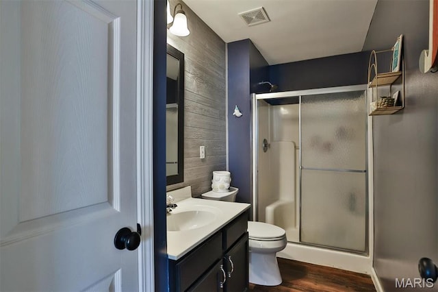 480 Benton Dr Unit J, Saint Peters, MO 63376 - bathroom with wood walls, a shower stall, vanity, toilet, and wood finished floors