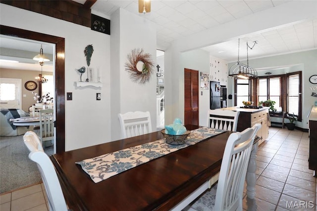 515 N Washington St, Mexico, MO 65265 - dining room featuring healthy amount of natural light, tile patterned flooring, and a chandelier