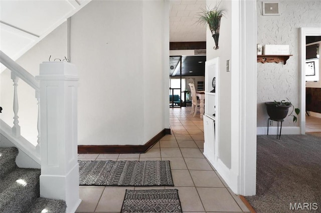 515 N Washington St, Mexico, MO 65265 - hall featuring stairway, baseboards, and tile patterned floors
