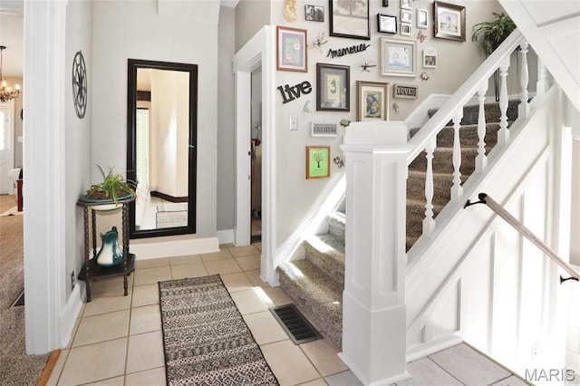 515 N Washington St, Mexico, MO 65265 - entryway with stairs, light tile patterned flooring, a chandelier, and baseboards