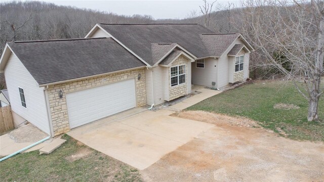 21680 N Horizonway N, Saint Robert, MO 65584 - view of front of house featuring roof with shingles, stone siding, driveway, and an attached garage