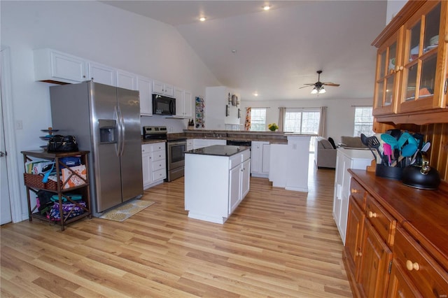 21680 N Horizonway N, Saint Robert, MO 65584 - kitchen with stainless steel appliances, a peninsula, dark countertops, open floor plan, and light wood-style floors