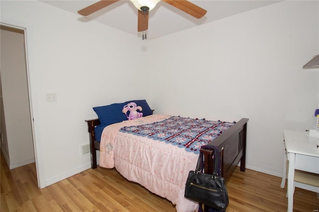 21680 N Horizonway N, Saint Robert, MO 65584 - bedroom featuring wood finished floors, baseboards, and a ceiling fan