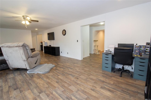 21680 N Horizonway N, Saint Robert, MO 65584 - living room featuring wood finished floors, a ceiling fan, a desk, and baseboards