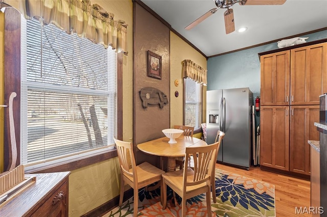 705 Jefferson St, Fulton, MO 65251 - dining area featuring a textured wall, light wood-type flooring, ceiling fan, healthy amount of natural light, and crown molding