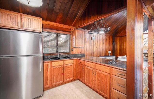 1382 Osage Rd, Cuba, MO 65453 - kitchen with freestanding refrigerator, lofted ceiling, a sink, black electric stovetop, and dark countertops