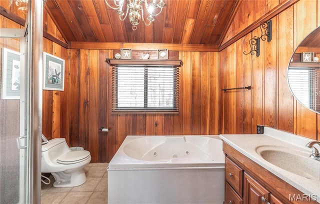 1382 Osage Rd, Cuba, MO 65453 - bathroom featuring a tub with jets, wooden walls, vanity, tile patterned floors, and toilet