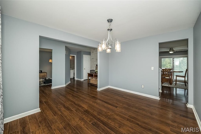 unfurnished dining area with dark wood-type flooring, baseboards, and a chandelier