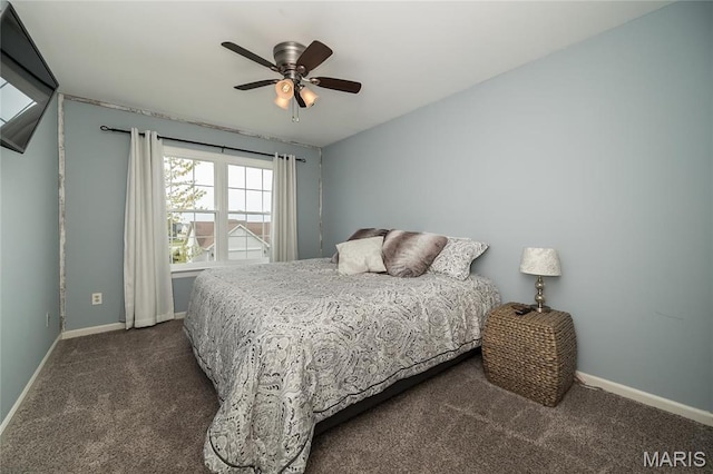 bedroom featuring dark colored carpet, baseboards, and a ceiling fan