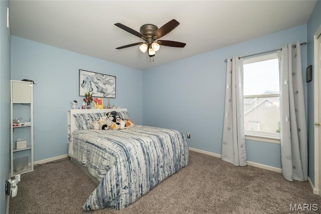 carpeted bedroom featuring baseboards and ceiling fan