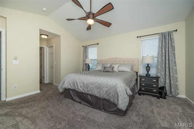 carpeted bedroom featuring vaulted ceiling, baseboards, and a ceiling fan