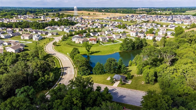aerial view of property's location with a large body of water and nearby suburban area